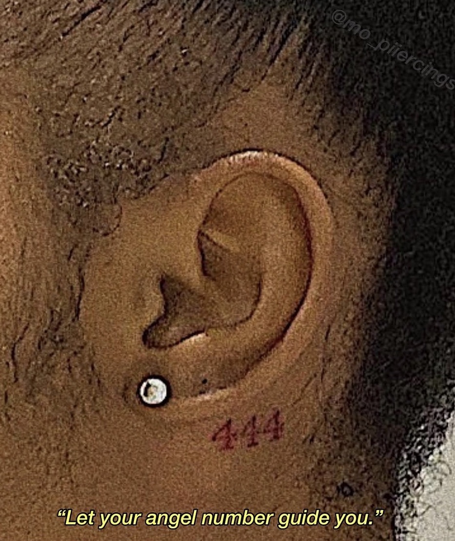 Lobe piercing with a tattooed angel number